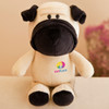 A beige and black plush toy resembling a dog, featuring a logo on its body. The toy has round eyes and a friendly expression.