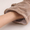A plush rhinoceros hand puppet in soft beige, featuring a hand inside the puppet's opening.