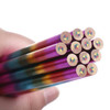A set of long, four-colour pencils in a hand, showcasing vibrant purple, blue, green, and orange hues at the ends.