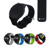 A round smart watch in black with a silicone strap, displayed alongside versions in grey, blue, green, and red.
