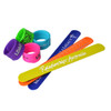 A collection of silicone slap bands in purple, blue, yellow, and green, featuring various logos and text.