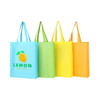 A collection of four non-woven bags in blue, green, yellow, and orange, featuring a logo on one bag.