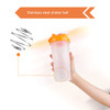 A drink bottle with an orange lid and a clear body, featuring a stainless steel shaker ball inside.