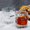 A whiskey glass set featuring square-shaped designs with one glass holding amber liquid and a cigar inserted.