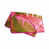 A flannel blanket featuring vibrant pink, green, and brown abstract patterns with a coloured border and a logo.