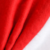 A red and white Santa hat made of soft fabric, featuring a fluffy white trim. It has a branding logo.