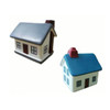 A house-shaped stress reliever in blue and white with windows and a chimney, featuring a logo.