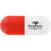 A capsule-shaped stress reliever in red and white with a logo on one side.