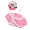 A lightweight pink umbrella with a wooden handle and a label indicating it’s made from recycled plastic bottles.