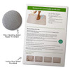 A grey bath mat made of diatomaceous earth with an instruction sheet and fine cleaning sandpaper included.
