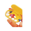 A yellow pill box held in a hand, containing various coloured pills and tablets in separate compartments.