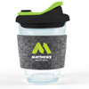 A reusable coffee cup with a clear body, black snap lid, and grey RPET band featuring a green logo.