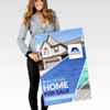 A woman holds a large promotional sign featuring a real estate advertisement with images of a home and pool.