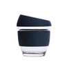 A reusable 8 oz glass coffee cup with a dark silicone sleeve and lid, featuring a sleek design.