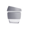 A reusable 8 oz glass coffee cup with a grey silicone lid and sleeve, featuring a simple design and a clear base.
