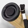 A bamboo torch with a black top and a woven strap for attachment. It features a circular textured button.