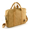 A tan kraft paper satchel with sturdy handles, a removable shoulder strap, and a logo patch.