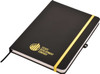 A black A5 notepad with a gold elastic band and a logo on the cover.