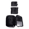 Three black packing cubes of varying sizes, with one open to reveal internal compartments, displaying a zippered design.