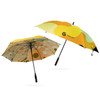 Two full colour golf umbrellas featuring vibrant patterns in yellow, orange, and beige, with one displaying a logo.