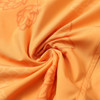 An orange polyester spandex fabric with a subtle pattern, showcasing the texture and drape.