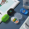 A collection of colourful pill boxes featuring multiple compartments, including green, blue, and transparent designs, with branding.
