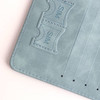 A light blue RFID multifunctional PU leather passport holder with slots for cards and SIM cards.