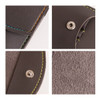 A portable manicure set in a brown case featuring colourful stitching and a metallic snap closure.