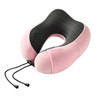 A pink and black memory foam U-shaped travel pillow with adjustable cords, featuring a soft exterior and a textured interior.