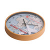 A round wall clock featuring a wood grain finish and a global travel theme with muted colours and an aircraft design.