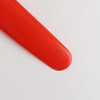 A red, V-shaped boomerang toy with a smooth finish, designed for throwing and catching.