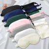 A collection of satin sleep masks in various colours, including black, green, pink, grey, and white, arranged neatly.