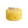 A round yellow candle shaped like cheese, featuring holes and a small flag on top.