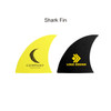 Two surfboard fins, one in bright yellow with a logo and text, and another in black with a different logo.