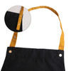 A black poly-cotton canvas apron with a yellow neck strap and snap buttons. Includes a close-up of the strap detail.