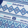A close-up of a knitted sweater featuring a blue and white jacquard pattern with a logo.