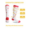 A pair of white compression socks with red accents, featuring a pattern and a logo.