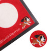 A red nylon logo mat features a playful dog design and a circular white area, with a black border around it.