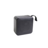 A portable wireless Bluetooth speaker in black with a textured surface and a carrying strap.