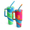 A drink bottle set featuring two 1200ml custom silicone cups in vibrant blue, green, and multicoloured swirls, with handles and straws.