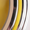 A close-up of a double ring wall clock with yellow, silver, and chrome accents. The design features a glossy finish.