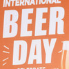 An orange rubber counter mat with a festive design, featuring graphics related to International Beer Day and a glass of beer.