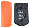 An orange Polar Blanket rolled next to a grey drawstring bag with a logo.