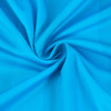 A close-up of a blue polyester fabric, showcasing a smooth texture with a spiral pattern. It has a subtle sheen.