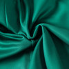 A close-up of smooth, teal fabric showcasing its softness and sheen, suitable for sporty bottoms.