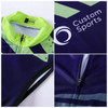 A cycling vest in purple and green with a zip closure and a logo, featuring a graphic design.