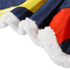 A close-up of a vibrant blanket featuring navy blue, red, and yellow colours with a plush white edge.