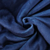 A textured, deep navy blue blanket made from 100% polyester, featuring a soft and luxurious appearance.