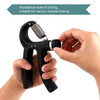 A hand holding a black adjustable hand grip with a metallic spring, featuring a resistance dial.