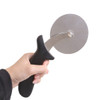 A pizza cutter with a stainless steel blade and a black ergonomic handle, held by a hand.